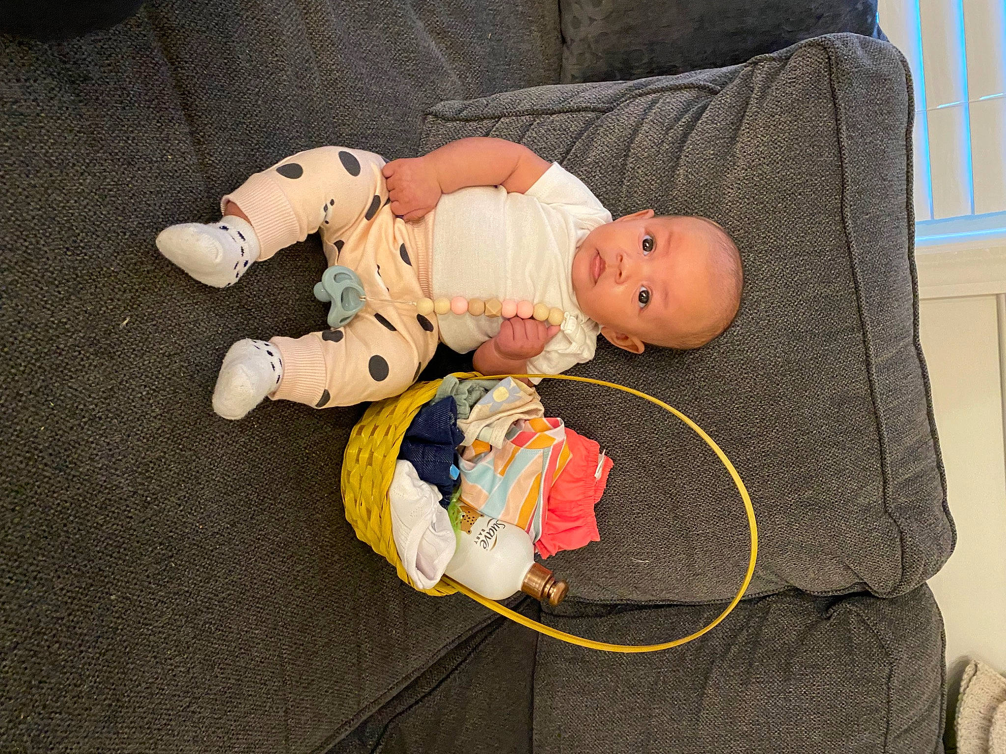 Legacy is registered to the contest to win money with this photo: baby, baby_products, baby_toddler_clothing, baby_toys, carmine, child, comfort, lap, linens, person, room, sock, toddler, window, wood