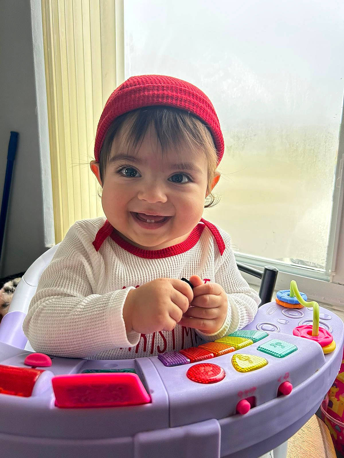 Karolina is registered to the contest to win money with this photo: automotive_design, baby, baby_playing_with_toys, baby_toddler_clothing, cap, cheek, child, eye, face, fun, happy, head, joy, person, riding_toy, room, skin, smile, tire, toddler