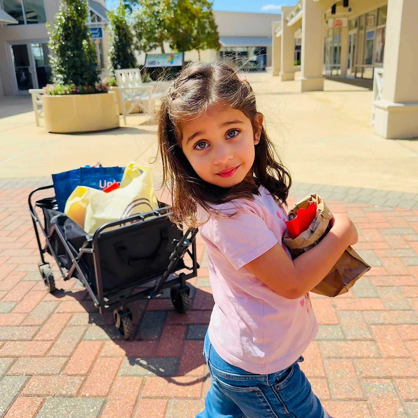 Maanya joined the competition — help win amazing prizes! accessories, bag, child, city, clothing, face, female, girl, handbag, head, jeans, neighborhood, pants, path, person, photography, portrait, road, street, urban