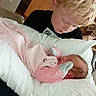 Delilah joined the competition — help win amazing prizes! child, baby, newborn, boy, pajamas, pillow, bedroom, hospital_room, curly_hair, blonde_hair, caring, family, indoor, sleeping_baby, tender_moment, jeans, socks, furniture, person, holding