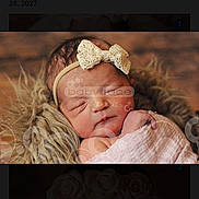 Delilah joined the competition — help win amazing prizes! newborn, baby, infant, sleeping, blanket, headband, bow, fur, soft_texture, portrait, cozy, cute, peaceful, wrapped, indoor, wood_background, closeup, photography, watermark, child