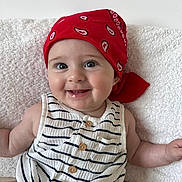 Louise participe au concours pour gagner de l'argent avec cette photo : baby, child, smiling, red_bandana, striped_clothing, sitting, happy, face, eyes, infant, cute, portrait, person, indoors, soft_background, white_background, closeup, skin, buttoned_clothing, baby_girl
