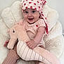 Louise a rejoint le concours — aidez-le/la à gagner de superbes lots ! baby, child, smiling, plush_toy, seahorse, headscarf, pink_clothing, striped_pants, chair, soft_furniture, happy, cute, indoor, portrait, person, infant, cozy, toy, baby_girl, comfortable
