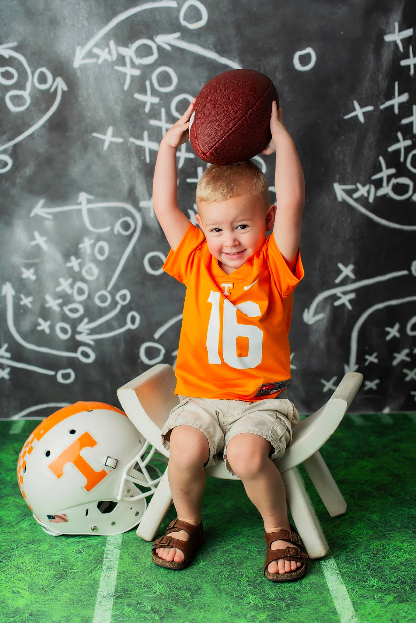 Neyland is registered to the contest to win money with this photo: ball, child, child_model, football, fun, jersey, joy, orange, person, play, player, sitting, soccer, soccer_ball, sports_gear, sports_uniform, sportswear, t_shirt, team_sport, toddler