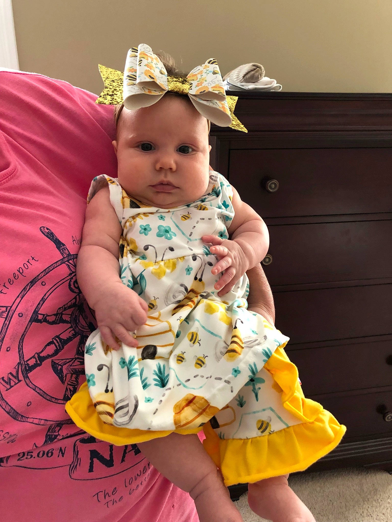 Blakeleigh joined the competition — help win amazing prizes! baby, baby_toddler_clothing, child, clothing, dress, fashion_accessory, hair_accessory, headband, headgear, headpiece, pattern, person, pink, sitting, smile, textile, toddler, yellow