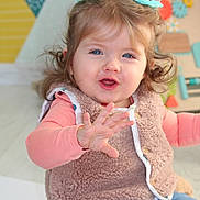 Sélène a rejoint le concours — aidez-le/la à gagner de superbes lots ! toddler, child, blue_eyes, smiling, vest, jeans, indoor, toy, playful, hair_ties, cute, happy, person, portrait, colorful_background, furniture, expression, candid, baby, clothing