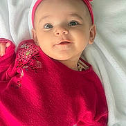 Lyna participe au concours pour gagner de l'argent avec cette photo : baby, infant, child, headband, pink_headband, sweater, red_sweater, blanket, lying_down, portrait, face, big_eyes, smile, cute, adorable, rosy_cheeks, soft_lighting, closeup, clothing, fabric