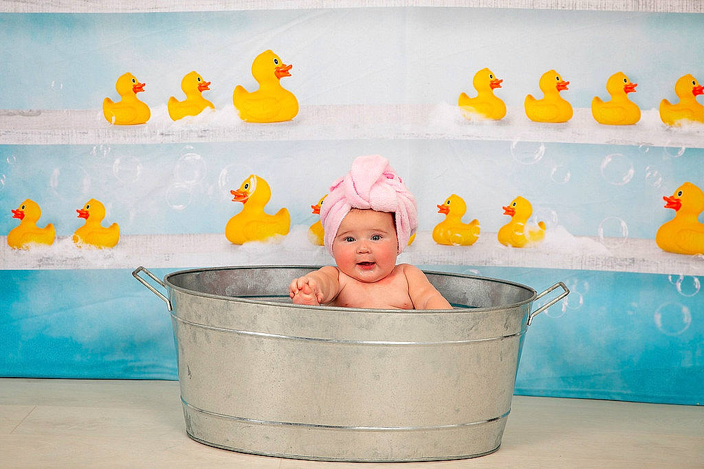 Jaida joined the competition — help win amazing prizes! baby, baby_bathing, bath_toy, bathing, bathtub, child, headwear, person, room, rubber_ducky, yellow