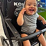 baby, child, smiling, shopping_cart, hoodie, striped_clothing, happy, indoor, person, seat, baby_cart, tooth, cute, shopping, retail, store, kid, toddler, black_cart, joyful