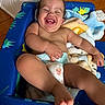 baby, blanket, blue_chair, child, comfort, curly_hair, cute, diaper, happy, indoor, person, playful, portrait, relaxed, skin, smiling, toddler, tooth, wall, wooden_floor