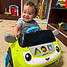 Albin joined the competition — help win amazing prizes! toddler, child, toy_car, smiling, curly_hair, indoor, playroom, floor, shelf, toy, colorful, happy_face, plastic, clothing, person, young_child, playing, cute, furniture, expression