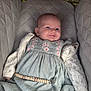baby, infant, smile, dress, knitted_sweater, beaded_clip, seat, cushion, comfort, portrait, cute, child, young, happy, face, eyes, clothing, fabric, indoor, person