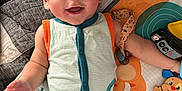 Hendrix joined the competition — help win amazing prizes! baby, helmet, smile, toy, play_mat, child, infant, colorful, cute, happy, lying_down, blue_helmet, onesie, indoors, face, expression, hand, arm, cheerful, bright