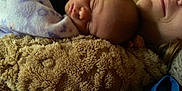 Sadie Mae is registered to the contest to win money with this photo: baby, sleeping, blanket, soft_texture, closeup, face, adult, resting, cozy, warm, indoor, comfort, parent, child, peaceful, cuddle, portrait, human, skin, relaxation