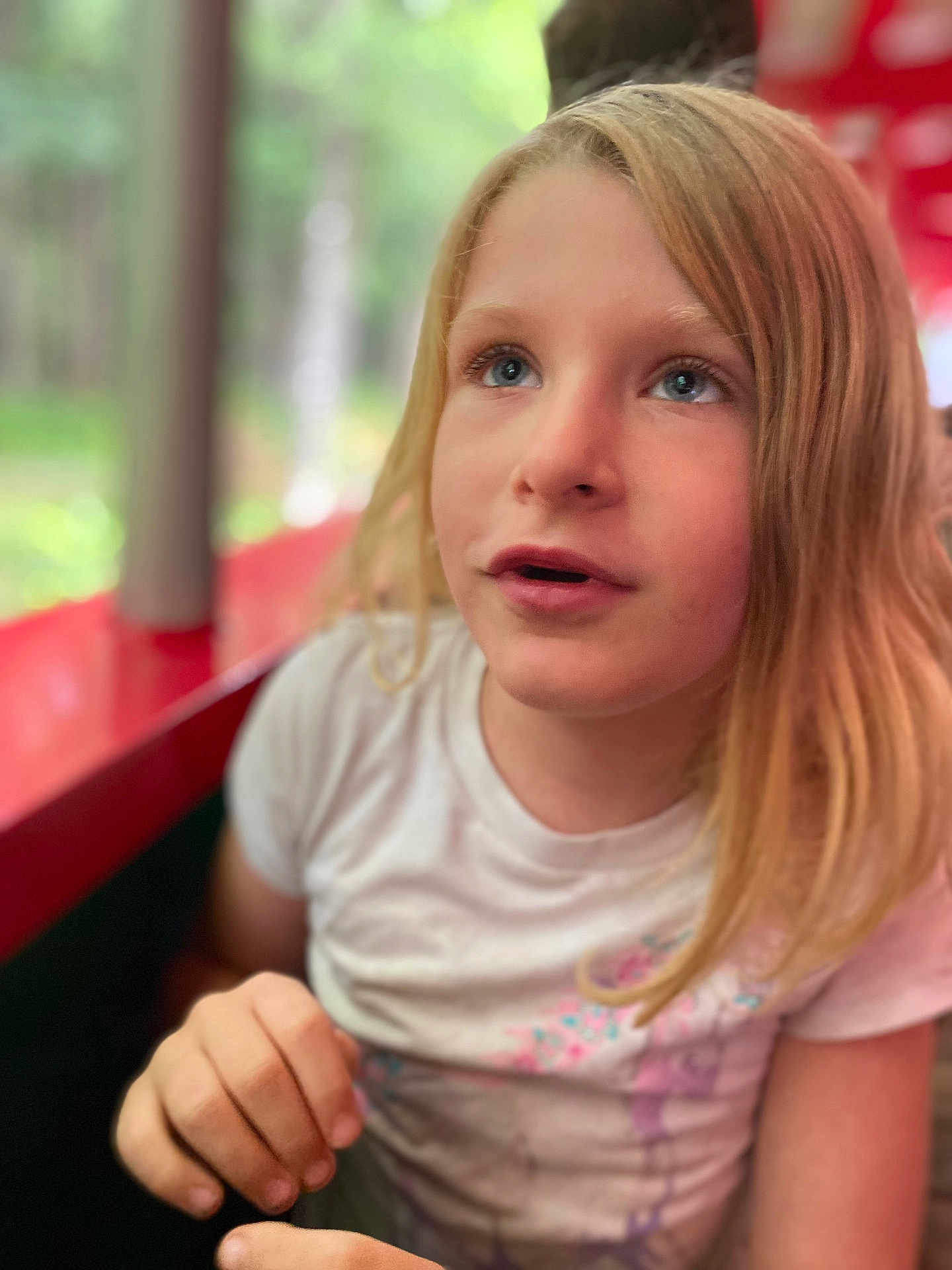 Rhyleigh-ann joined the competition — help win amazing prizes! child, girl, blonde_hair, blue_eyes, white_shirt, portrait, close_up, outdoor, nature, red_structure, casual_clothing, curious_expression, person, young, human, face, hand, sitting, daylight, soft_focus