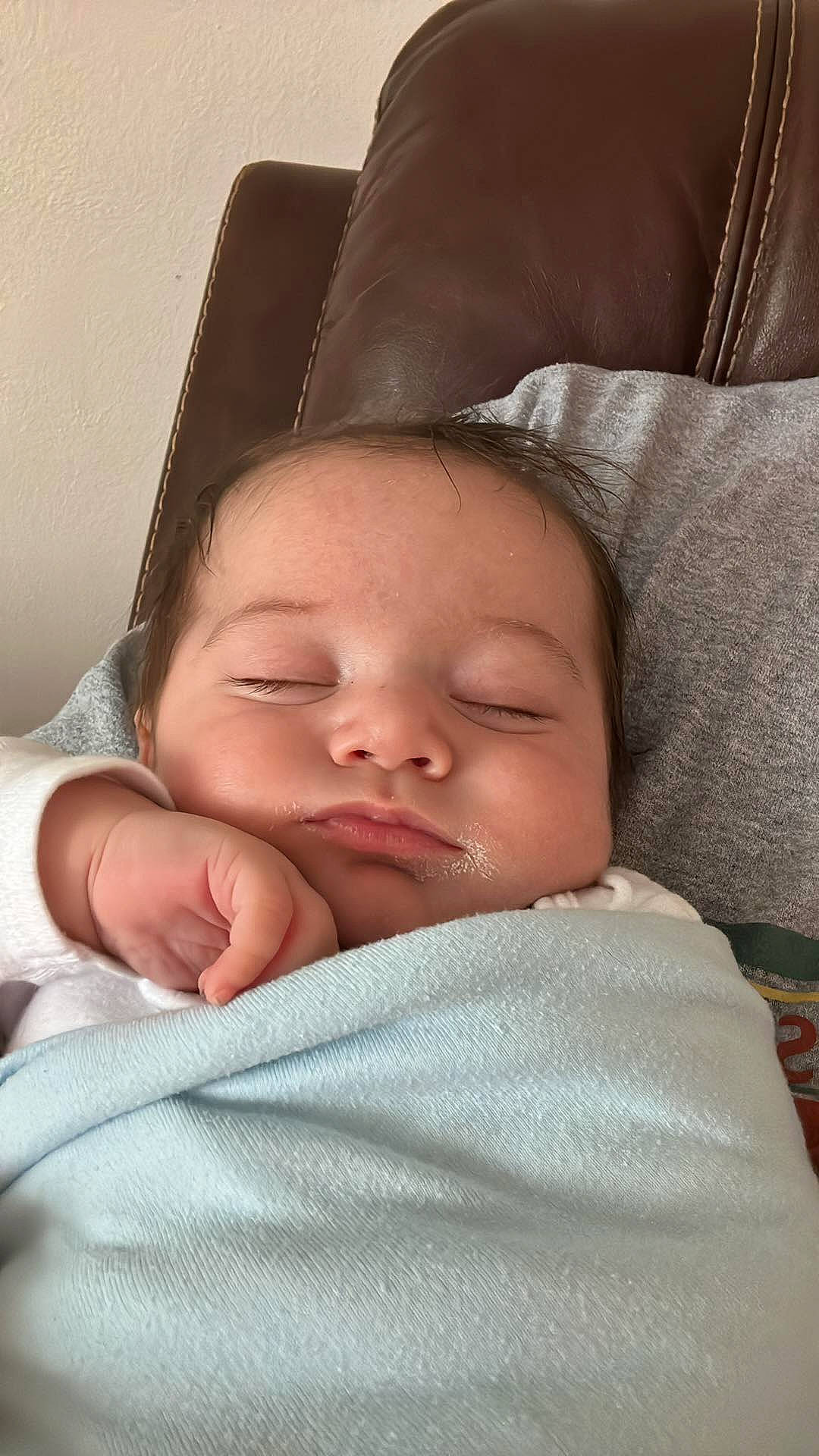 John is registered to the contest to win money with this photo: baby, baby_sleeping, baby_toddler_clothing, cheek, chin, comfort, eye, eyebrow, face, facial_expression, finger, head, linens, lip, mammal, mouth, nose, person, skin, textile