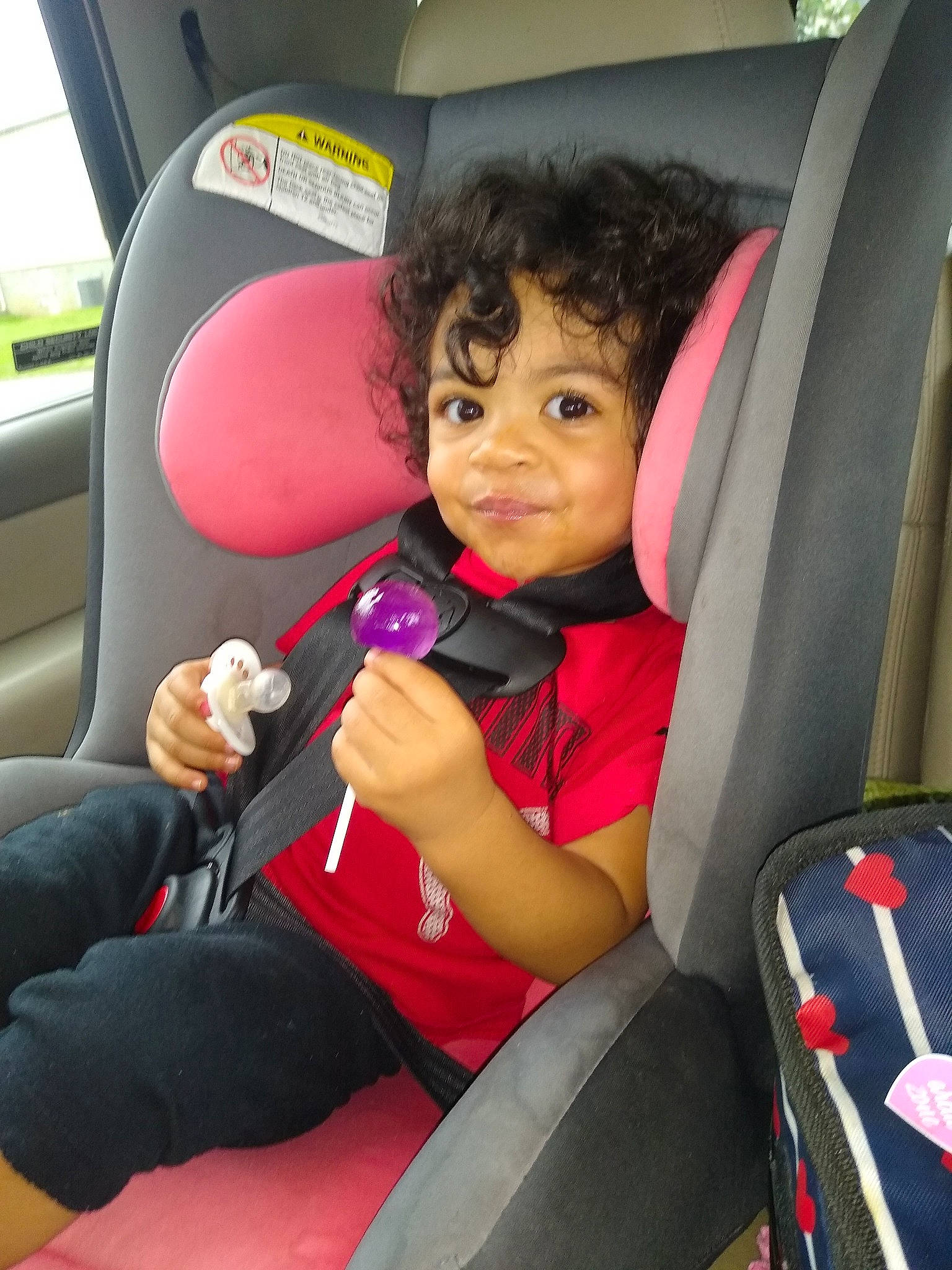 Tahiry is registered to the contest to win money with this photo: auto_part, baby_in_car_seat, black_hair, car, car_seat, car_seat_cover, child, family_car, head_restraint, passenger, person, seat_belt, vehicle, vehicle_door