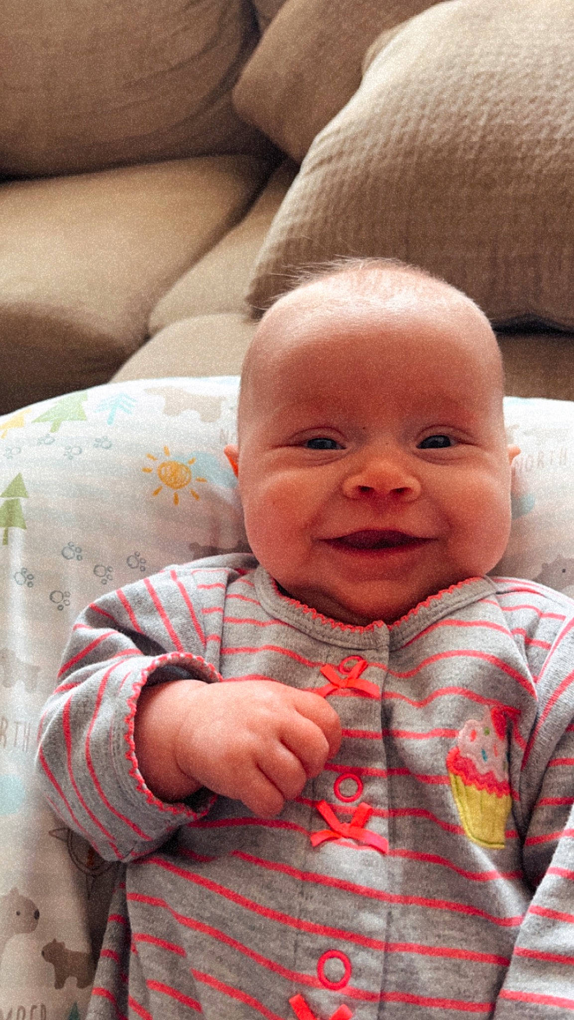 Caroline is registered to the contest to win money with this photo: baby, baby_toddler_clothing, cheek, child, comfort, couch, happy, iris, linens, lip, nose, pattern, person, plaid, sitting, skin, sleeve, smile, tartan, textile