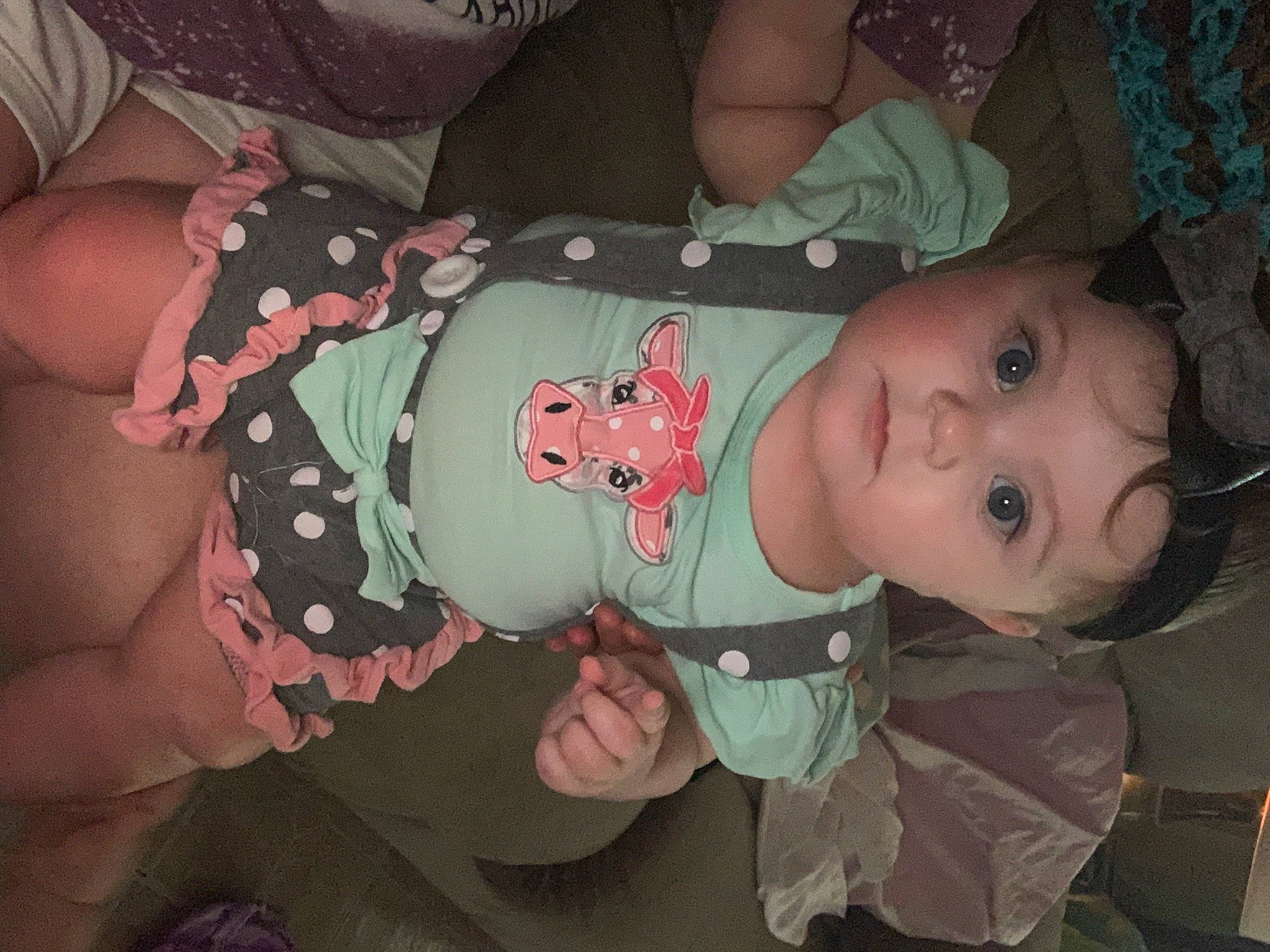 Cailyn is registered to the contest to win money with this photo: arm, baby, baby_products, baby_toddler_clothing, cheek, child, eye, facial_expression, human_body, iris, mouth, nose, organ, pattern, person, skin, sleeve, smile, thigh, toddler