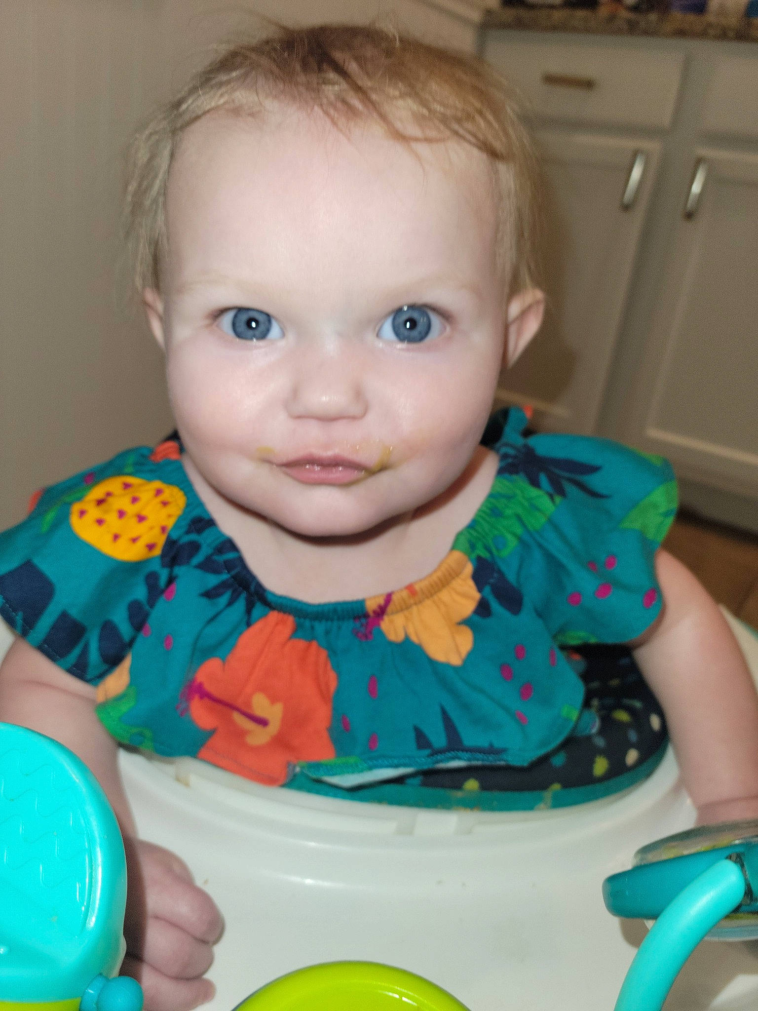 Chloe is registered to the contest to win money with this photo: arm, baby, baby_playing_with_toys, baby_toddler_clothing, blue, cabinetry, cheek, child, eye, finger, fun, hairstyle, happy, iris, kitchen_appliance, mouth, nose, person, skin, smile