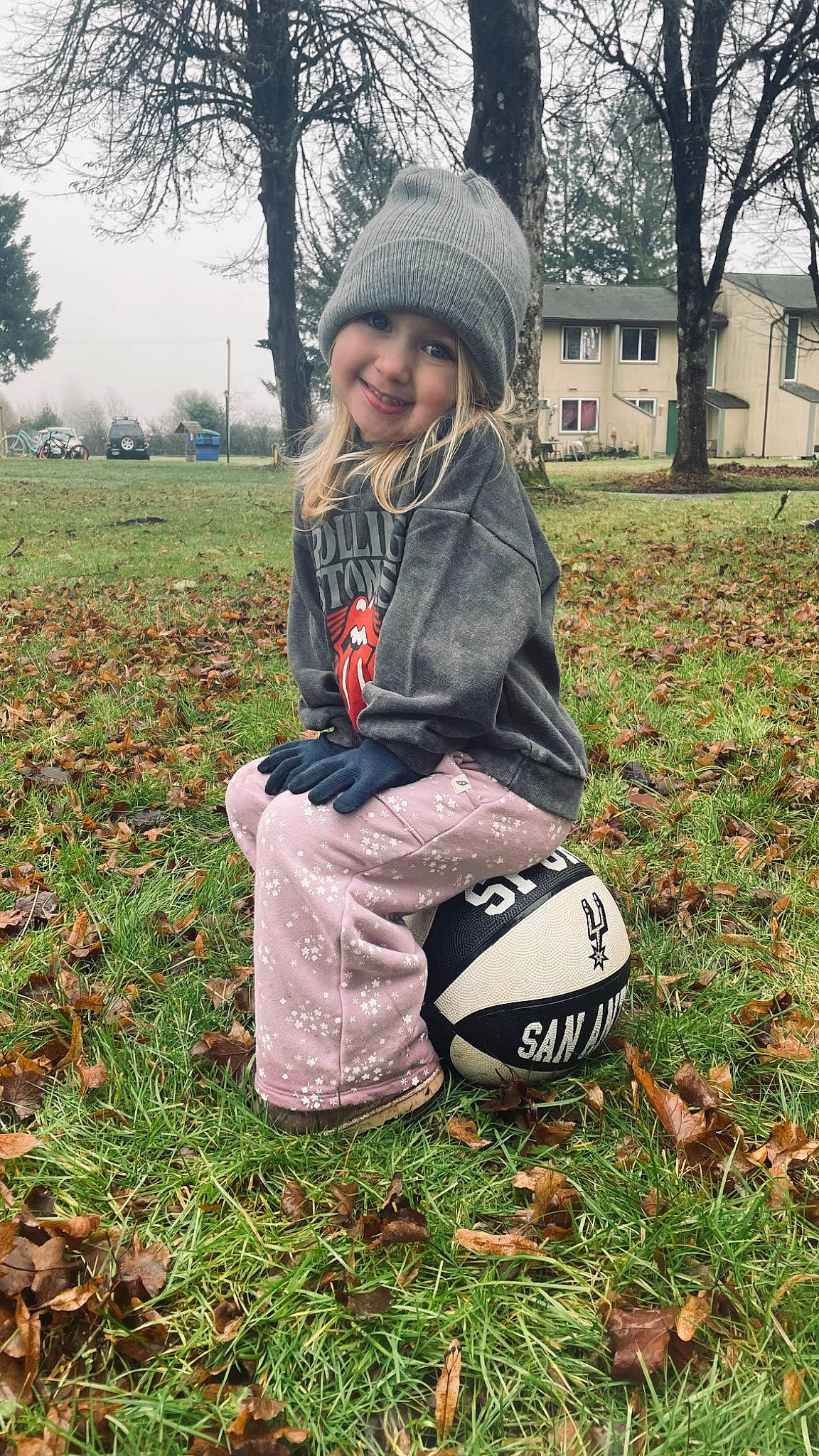 Olive is registered to the contest to win money with this photo: bag, ball, boot, face, football, grass, grassland, happy, headwear, joy, leaf, outerwear, pattern, people_in_nature, person, plant, sky, smile, sports_equipment, spring