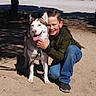 Kona is registered to the contest to win money with this photo: boy, child, dog, husky, pet, outdoor, park, sunlight, smiling, crouching, animal, leash, tree, dirt, casual_clothing, blue_jeans, jacket, happy, nature, daytime