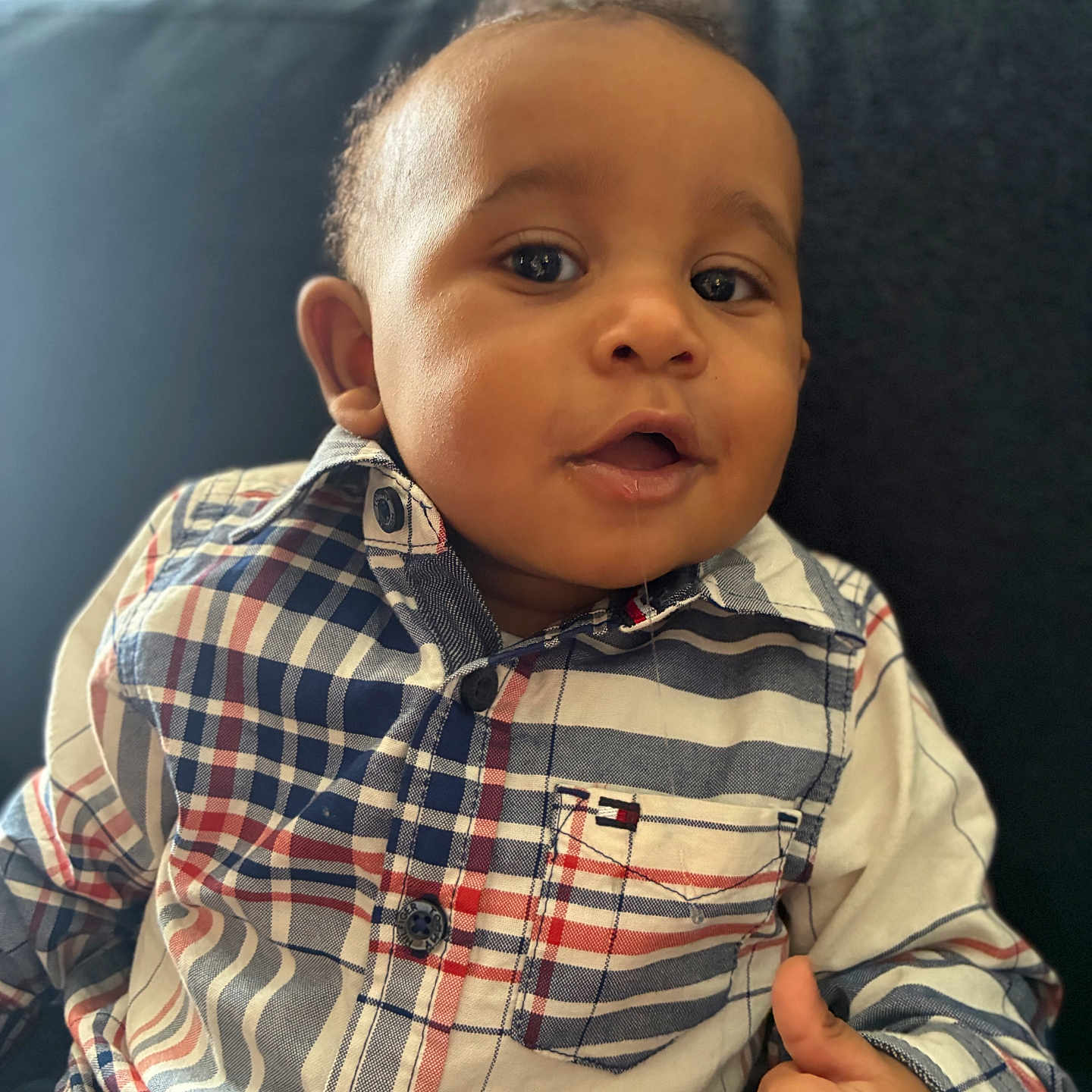 Bryson joined the competition — help win amazing prizes! baby, child, portrait, close_up, face, smiling, thumbs_up, sitting, sofa, indoors, plaid_shirt, fashion, infant, looking_at_camera, dark_sofa, natural_light, photography, happy, cute, headshot