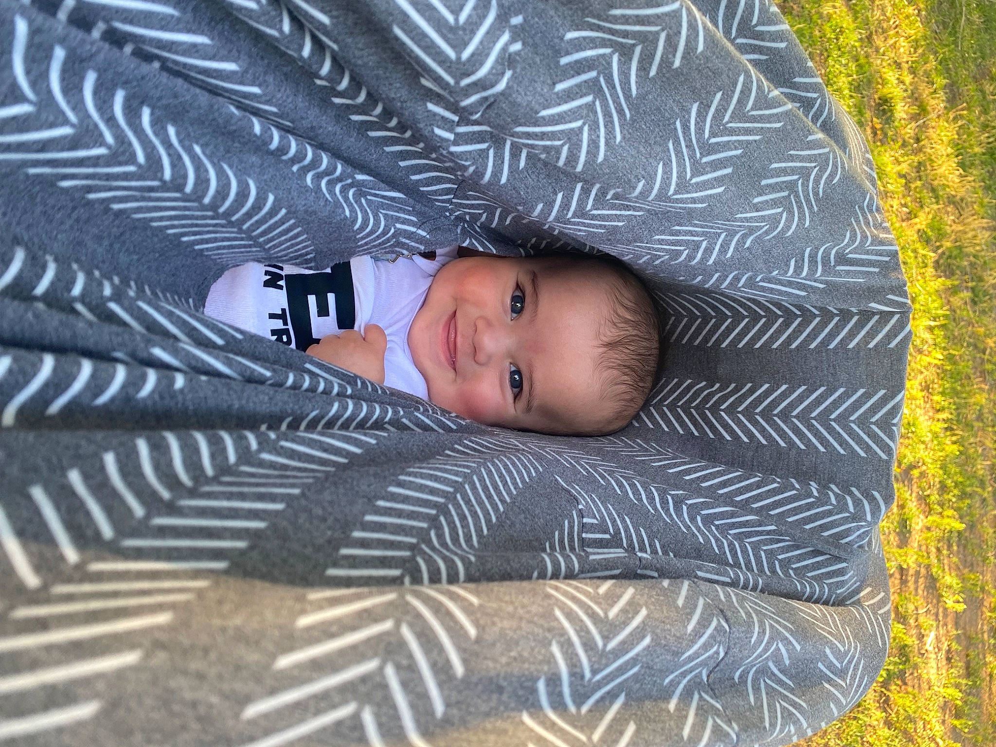Beckham is registered to the contest to win money with this photo: baby, electric_blue, eye, face, flash_photography, flooring, fun, grass, head, joy, leaf, pattern, people_in_nature, person, plant, skin, smile, textile, tints_and_shades, toddler