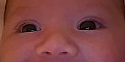 Jaxon is registered to the contest to win money with this photo: baby, smiling, close_up, face, infant, happy, child, eyes, mouth_open, blanket, cozy, cute, skin, head, indoors, portrait, young_child, expression, human, warm
