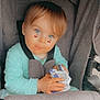 toddler, child, stroller, baby, blue_eyes, cherry_sticker, onesie, mint_green, hand, face, seatbelt, snack_wrapper, gray_fabric, cute, indoor, portrait, young_child, sitting, infant, expression