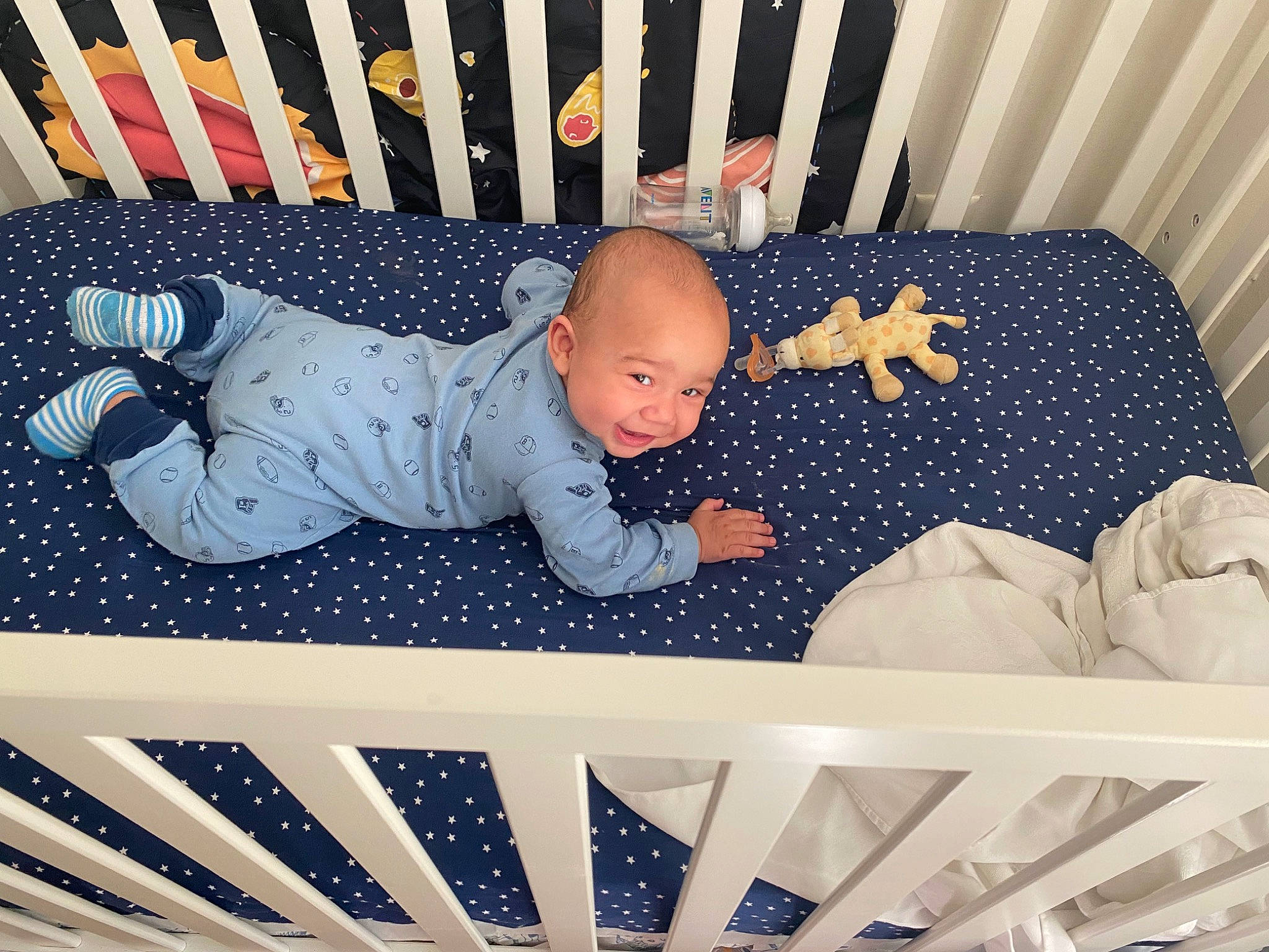 Darrell is registered to the contest to win money with this photo: baby, baby_products, baby_safety, baby_toddler_clothing, blue, child, comfort, cradle, facial_expression, human_body, infant_bed, line, organ, person, photograph, product, smile, snapshot, textile, toddler