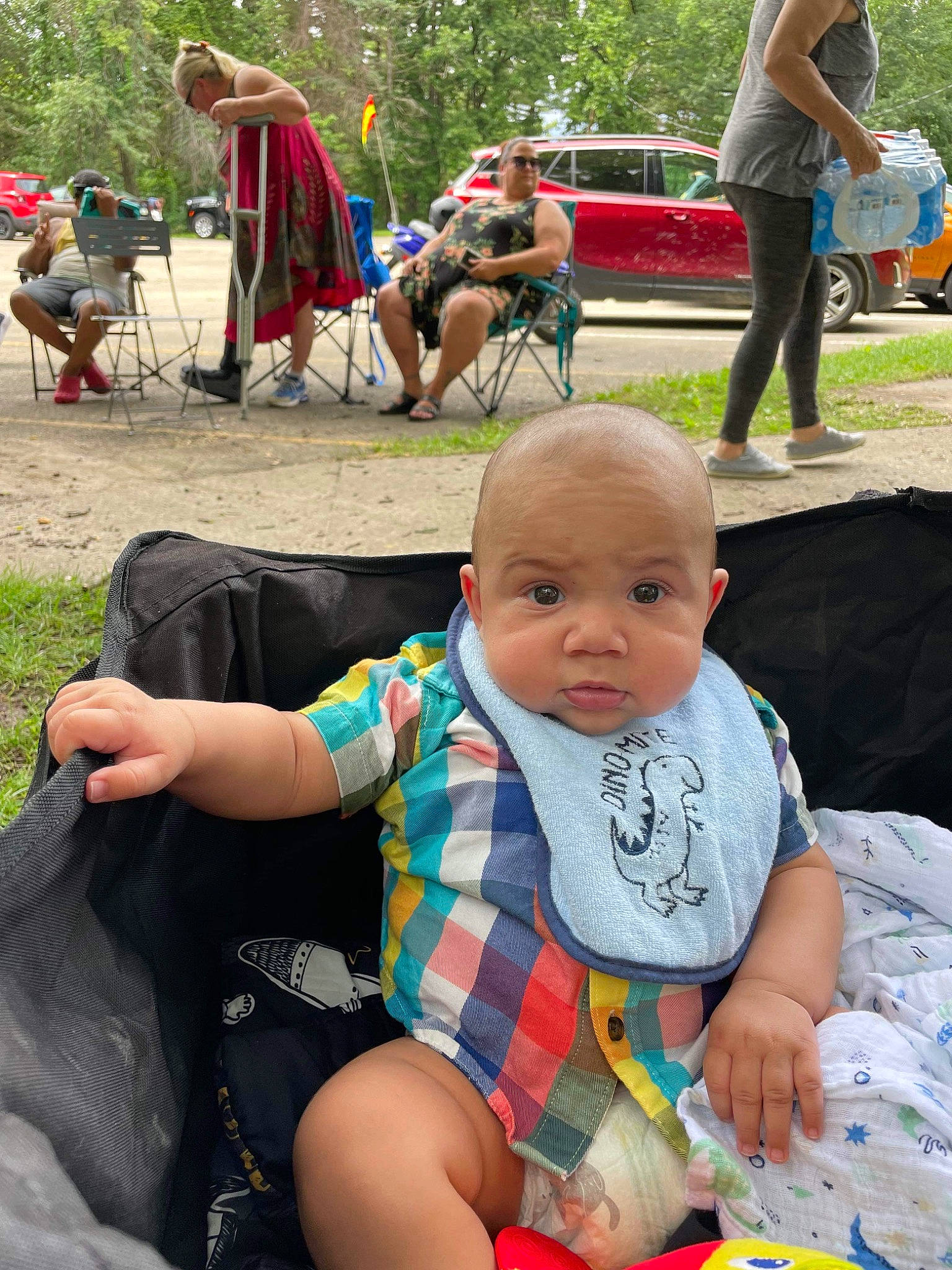 Darrell joined the competition — help win amazing prizes! baby, baby_toddler_clothing, chair, event, fun, grass, green, lap, leisure, people, person, plant, recreation, shorts, sitting, summer, t_shirt, tire, toddler, tree