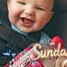 baby, child, smiling, car_seat, seatbelt, drink_bottle, red, face, happy, indoors, portrait, young_child, cute, holding, close_up, expression, person, bottle, casual, daylight