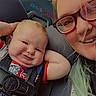 Kyler joined the competition — help win amazing prizes! baby, child, car_seat, seatbelt, smile, happy, person, adult, glasses, hair, blond, inside, vehicle, window, seat, casual_clothing, closeup, portrait, candid, family