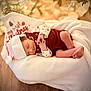 baby, blanket, christmas, cozy, cute, decorations, festive, holiday, holiday_season, indoors, infant, newborn, peaceful, portrait, relaxing, santa_hat, sleeping, soft_lighting, warm_colors, wood_floor