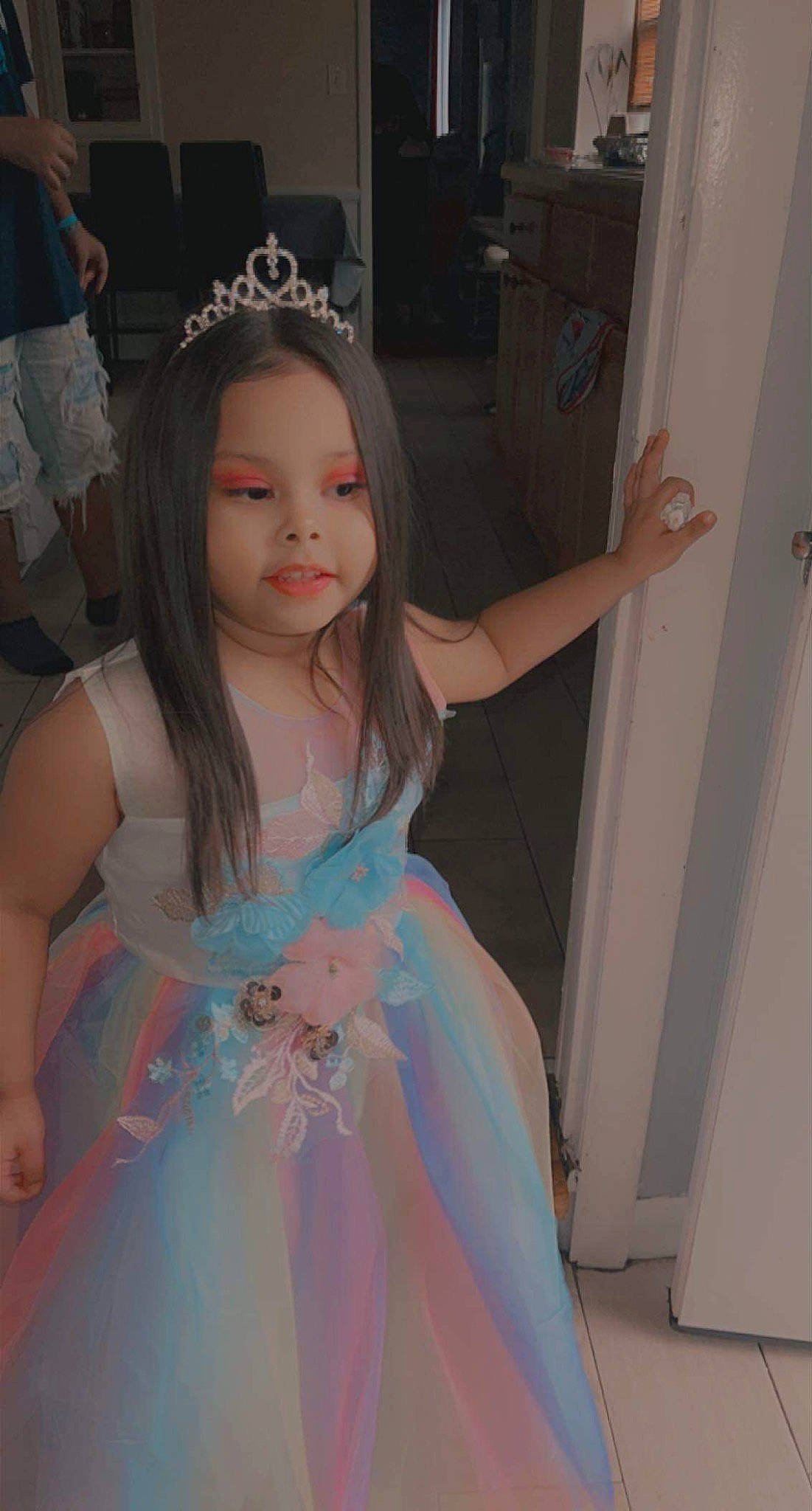 Nalani is registered to the contest to win money with this photo: bridal_accessory, dress, event, eye, fashion_design, formal_wear, fun, gown, hairstyle, happy, headpiece, iris, long_hair, mythical_creature, person, pink, shorts, skin, standing, toddler