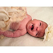 Jayla joined the competition — help win amazing prizes! baby, infant, smiling, headband, flower, blanket, soft_texture, cute, newborn, lying_down, happy, skin, portrait, child, tulle, fabric, closeup, indoors, adorable, young