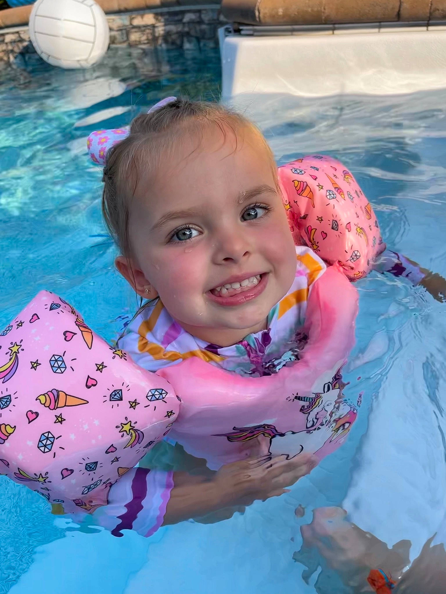 Sky'Lee is registered to the contest to win money with this photo: aqua, azure, baby_toddler_clothing, cheek, child, eye, face, facial_expression, fun, happy, joy, leisure, person, pink, product, recreation, skin, smile, summer, swimming_pool