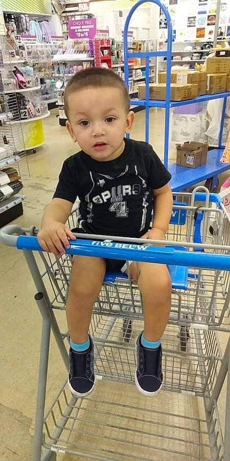 Ezekiel is registered to the contest to win money with this photo: customer, electric_blue, fun, human_leg, joint, knee, leg, leisure, person, photograph, product, retail, shelf, shoe, shopping_cart, shorts, smile, sneakers, standing, thigh