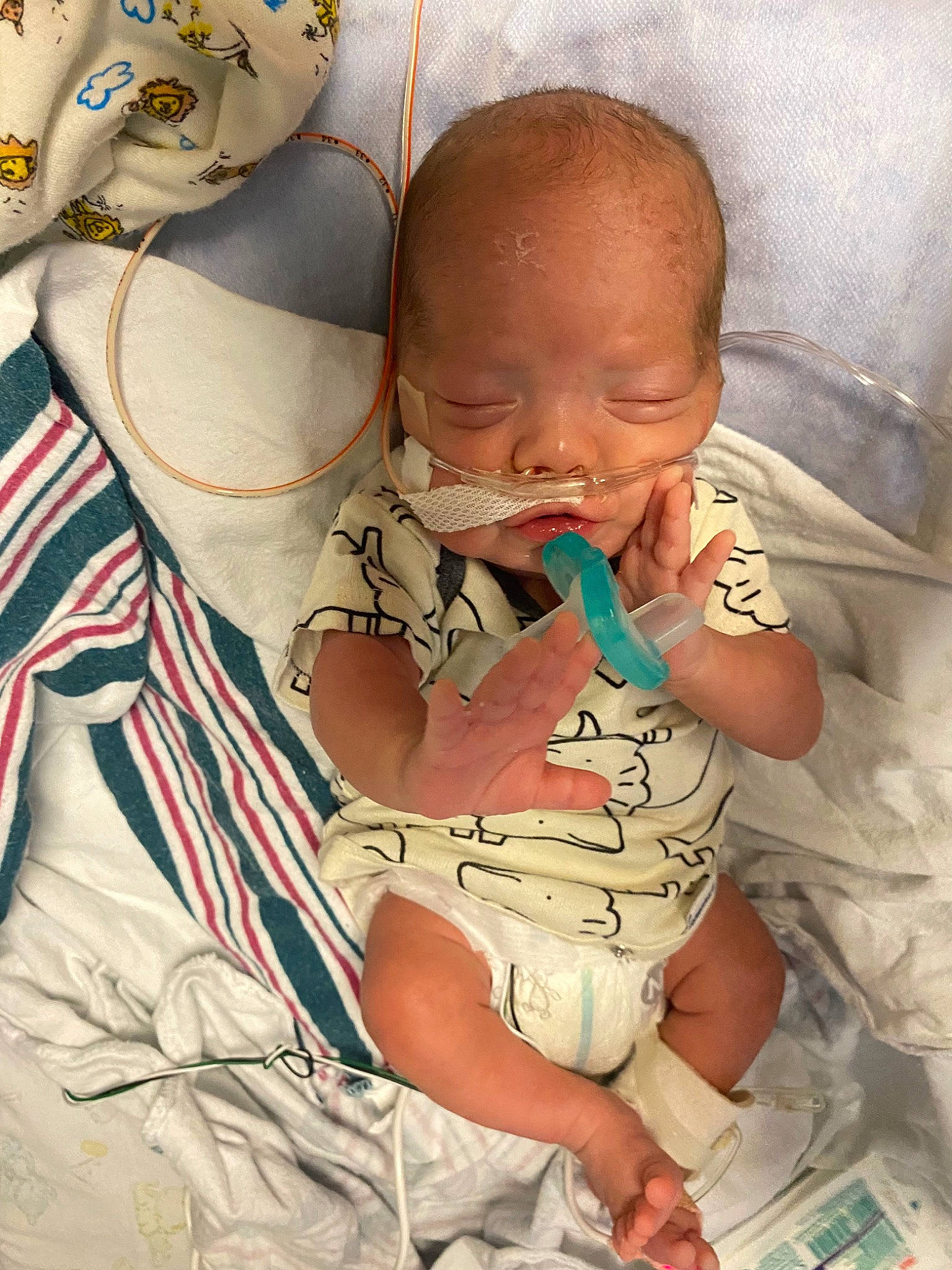 Asher is registered to the contest to win money with this photo: arm, baby, baby_products, baby_toddler_clothing, cheek, child, comfort, eye, finger, fun, hand, happy, head, human_body, linens, mouth, person, product, sitting, skin