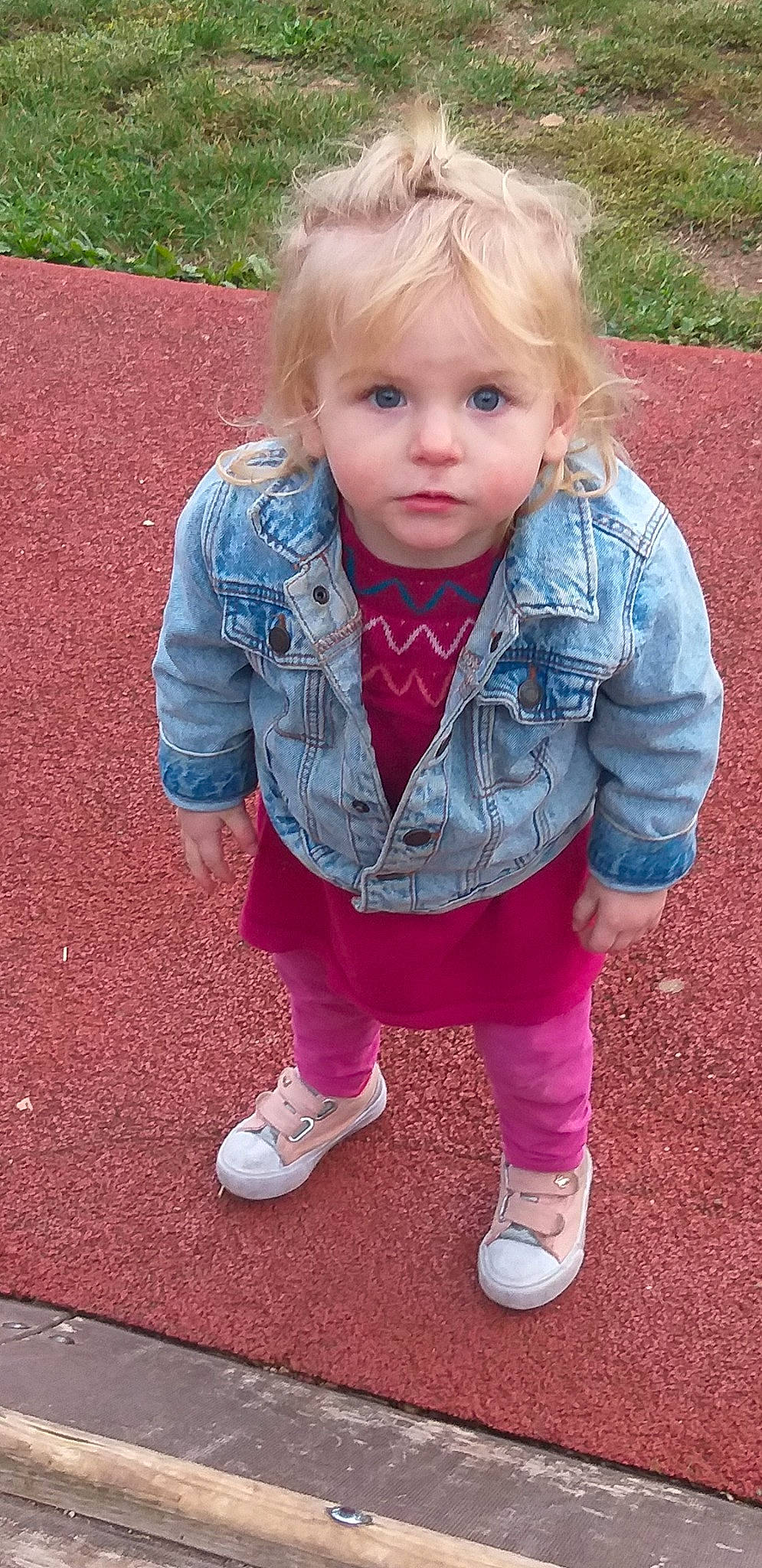 Aïna a rejoint le concours — aidez-le/la à gagner de superbes lots ! blond, child, child_model, grass, hair, jacket, jeans, outerwear, person, pink, play, playground, sitting, smile, toddler