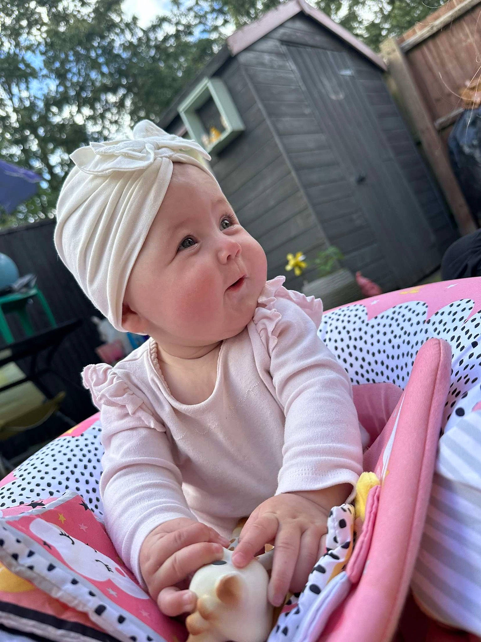 Esmae joined the competition — help win amazing prizes! baby, baby_carriage, baby_products, baby_toddler_clothing, chair, child, comfort, event, fun, grass, happy, hat, lap, leisure, person, pink, recreation, sitting, smile, toddler