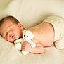 baby, newborn, sleeping, teddy_bear, soft_texture, cream_color, blanket, infant, cute, peaceful, child, adorable, resting, clothing, skin, portrait, hand, lying_down, nursery, comfort