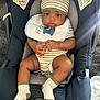 Lenox is registered to the contest to win money with this photo: baby, car_seat, bib, hat, socks, infant, child, striped_clothing, cute, hands, face, eyes, seatbelt, newborn, indoor, person, clothing, cute_pie, car_interior, sitting