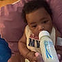 Lenox is registered to the contest to win money with this photo: baby, infant, bottle, feeding, cushion, hand, milk, indoor, closeup, person, child, cute, clothing, pink, soft, relaxing, young, portrait, feedingtime, toddler