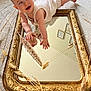 baby, carpet, child, cute, decor, dried_grass, face, floor, frame, hands, head, indoor, infant, light, mirror, playful, portrait, reflection, smiling, white_clothing