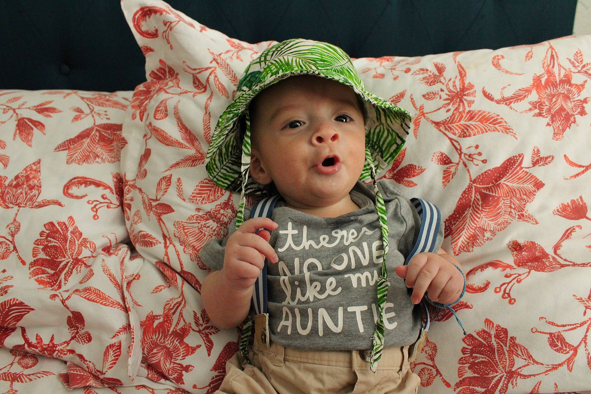 Matías joined the competition — help win amazing prizes! baby, baby_toddler_clothing, cap, child, finger, gesture, hand, happy, headwear, human, human_body, leaf, linens, pattern, person, pink, skin, sleeve, smile, sun_hat