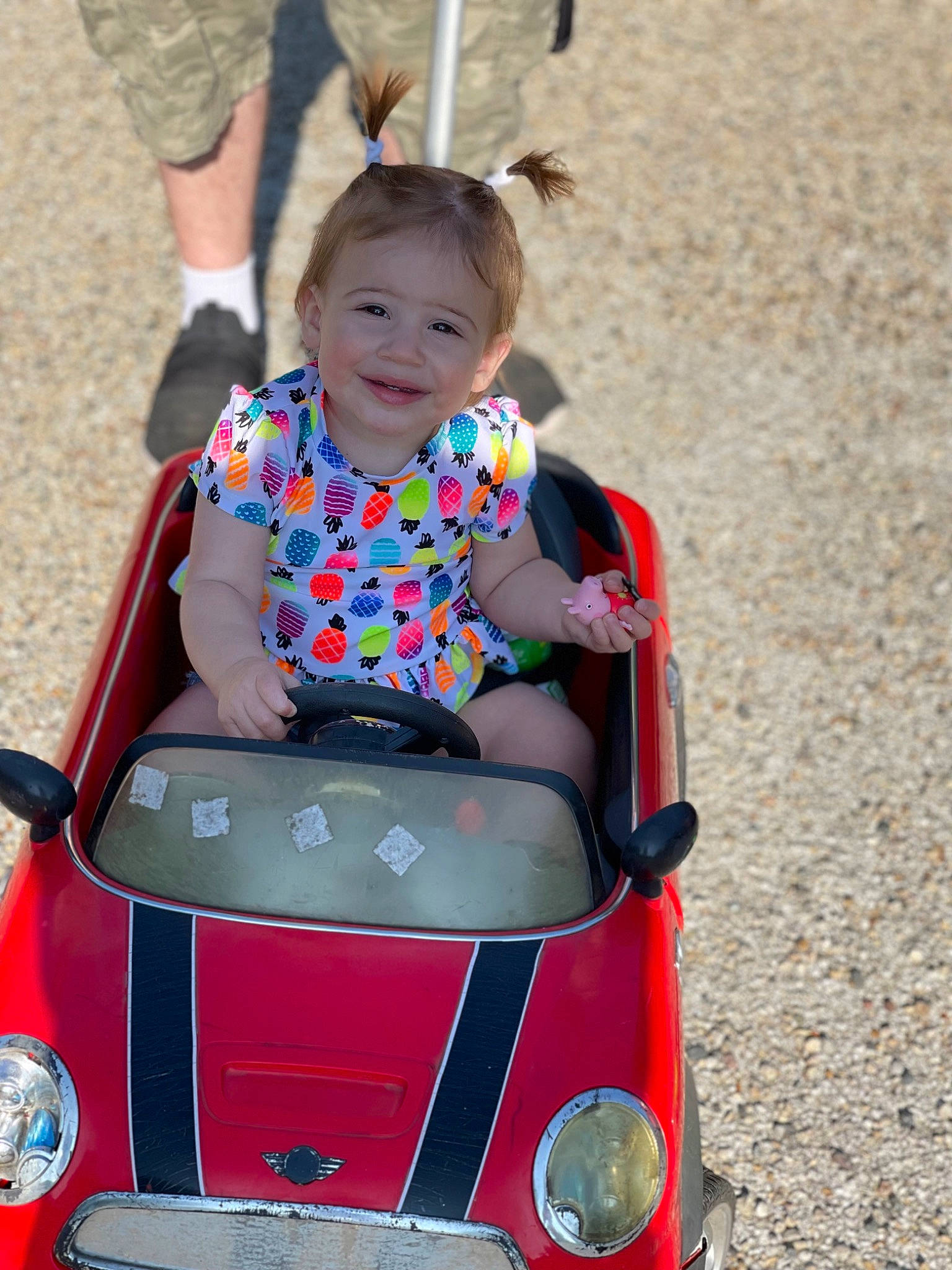 Emmerson is registered to the contest to win money with this photo: automotive_design, automotive_exterior, automotive_lighting, bumper, child, eye, facial_expression, fun, hair, happy, joy, leisure, motor_vehicle, person, riding_toy, smile, tire, toddler, travel, vehicle