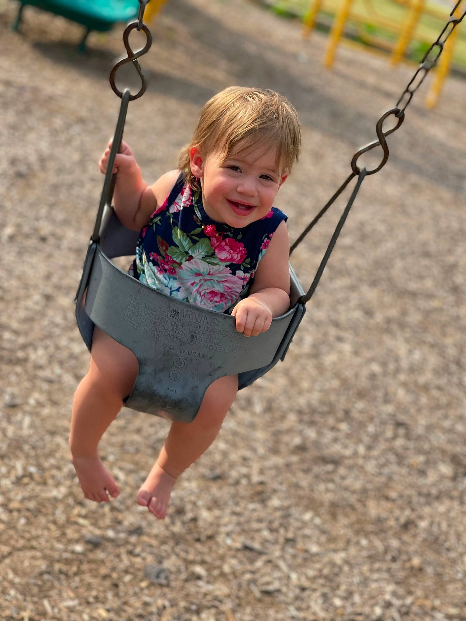 Emmerson is registered to the contest to win money with this photo: arm, baby, child, city, face, fun, grass, hand, happy, joy, leisure, people_in_nature, person, playground, recreation, sleeve, smile, swing, t_shirt, toddler