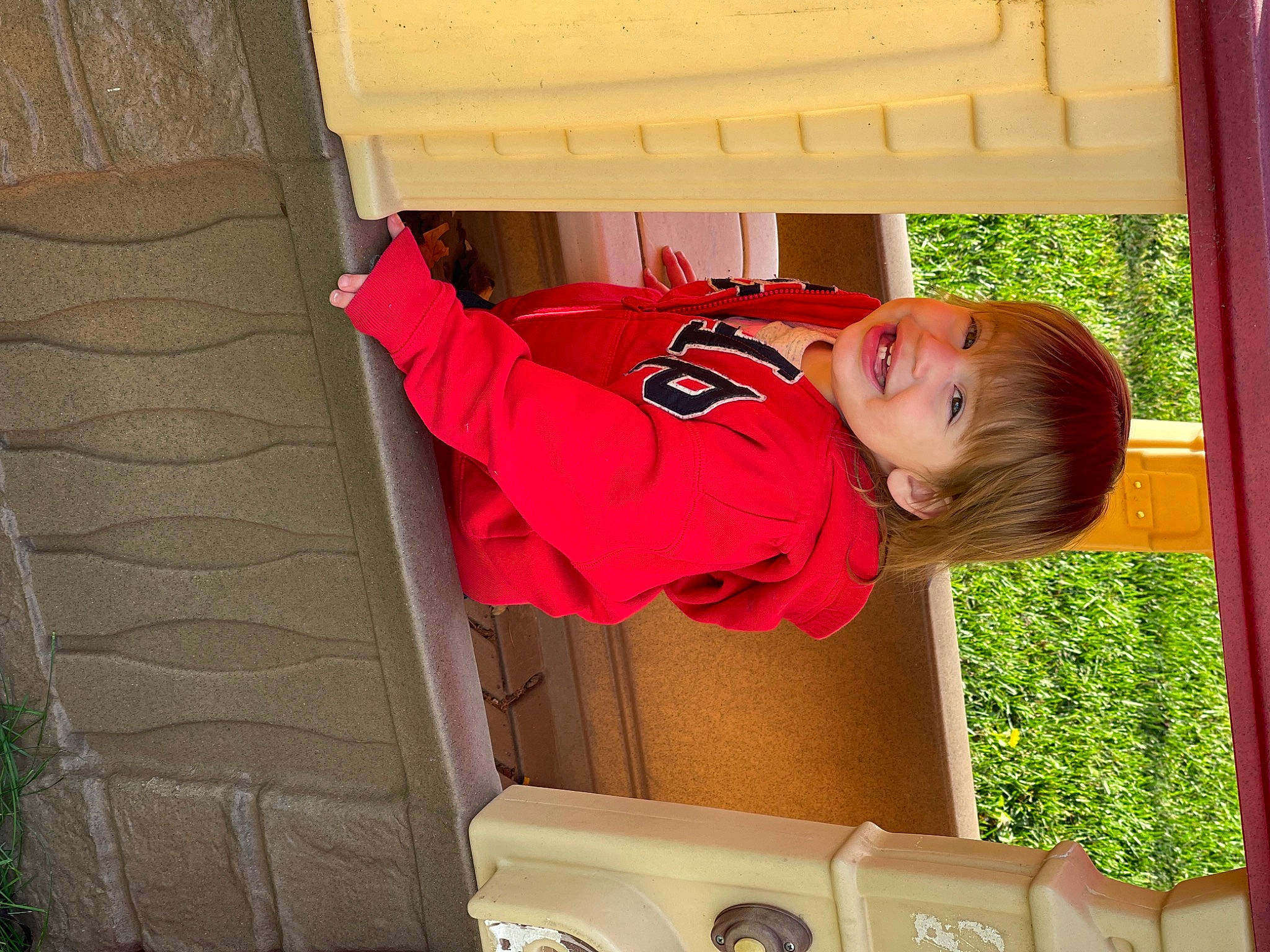 Enmerson is registered to the contest to win money with this photo: baby, baby_toddler_clothing, child, door, flooring, fun, grass, happy, house, joy, leisure, magenta, person, plant, play, room, smile, t_shirt, toddler, tree